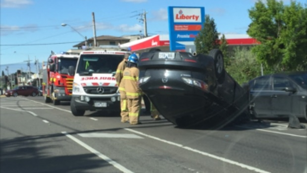 Article image for Emergency crews at the scene after car flips Reservoir