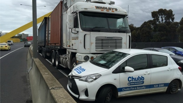 Article image for Car stuck under truck on Tullamarine Freeway