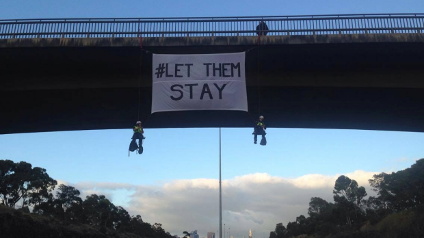 Article image for Protest unfurl #LetThemStay banner on Eastern Freeway