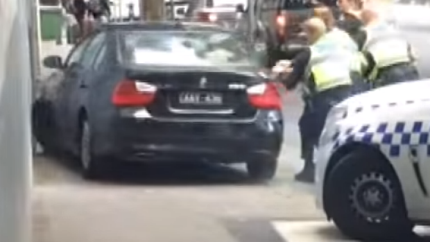 Article image for Police arrest man wanted over chaotic CBD chase in black BMW