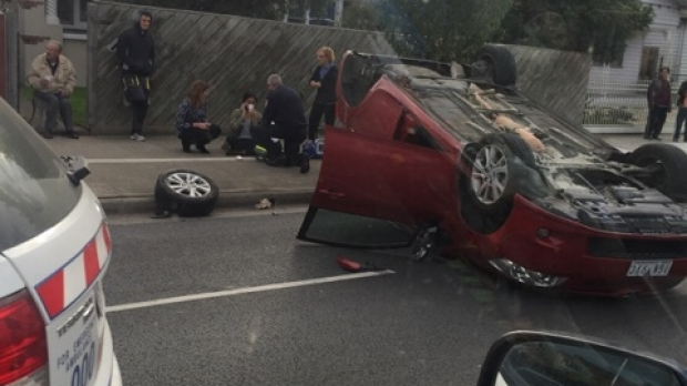 Article image for Paramedics are treating the driver of a car that flipped onto it’s roof at Coburg
