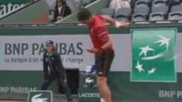 Article image for Tennis champ Novak Djokovic throws racquet, narrowly misses linesman