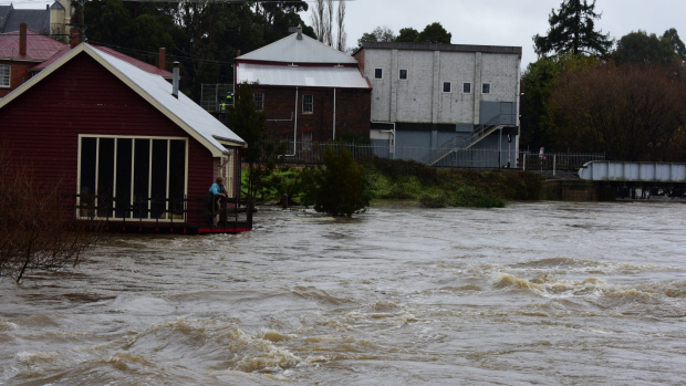 Article image for Police officer saves family from flood waters in Tasmania