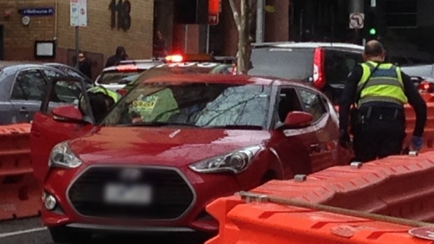 Article image for WATCH: Police tackle woman who flees car after bizarre CBD chase