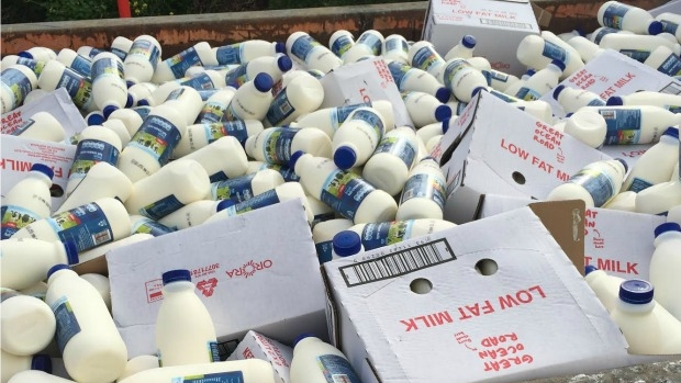 Article image for Thousands of full milk bottles thrown into skip bin at Coles Distribution Centre at Truganina