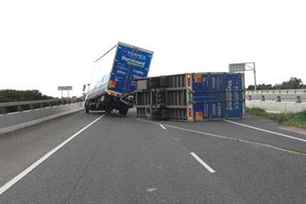 Article image for Truck flips as Melbourne prepares for wild and windy day