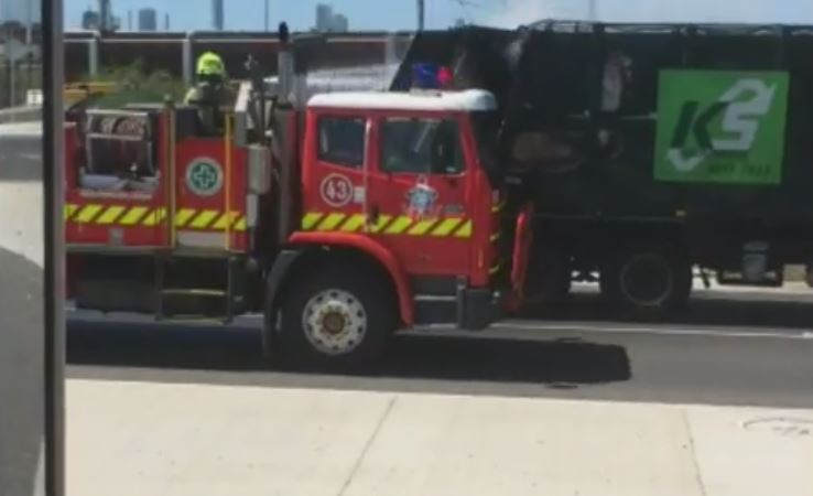 Article image for Bizarre footage emerges of a garbage truck being hosed down while on the move