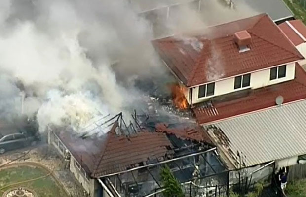 Article image for Schools told to stay inside as house goes up in flames