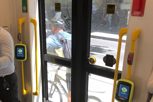 Article image for Tom Elliott snaps cyclist getting a free ride by holding onto tram