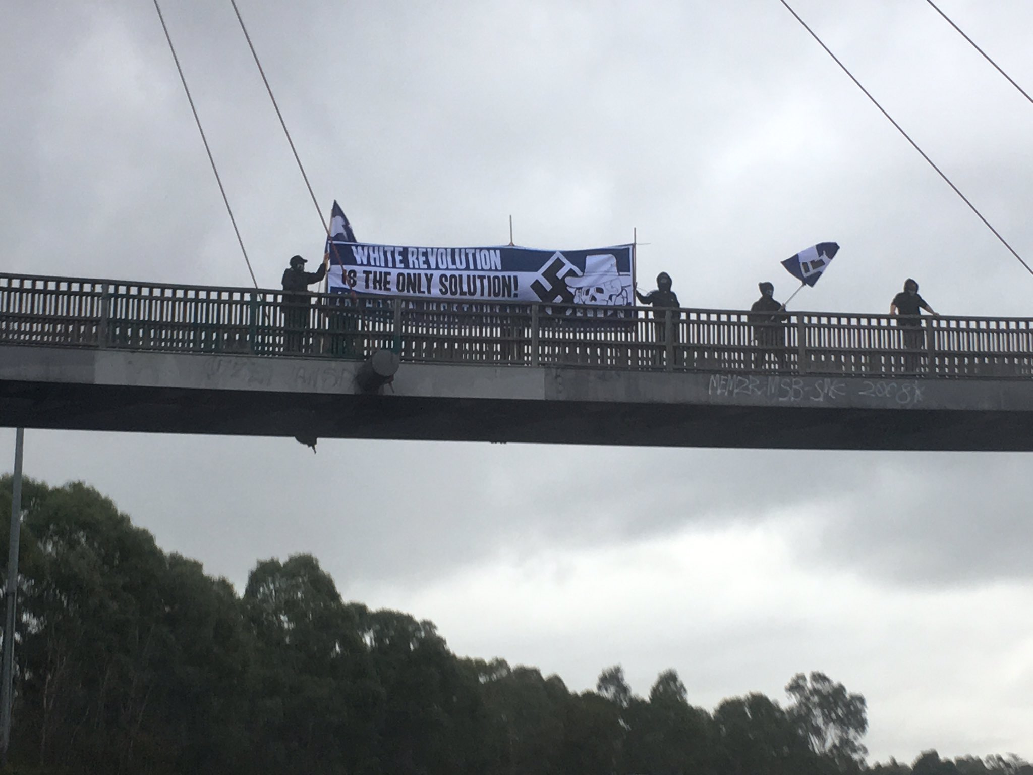 Article image for White supremacists hang racist banner over Eastern freeway