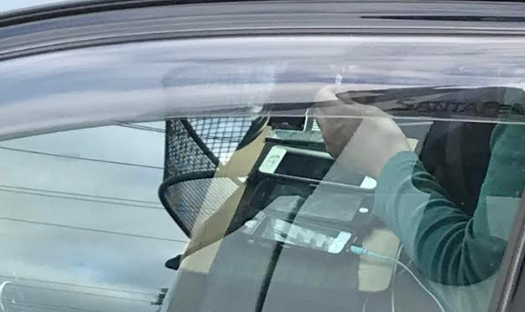 Article image for Driver snapped using multiple phones on busy road