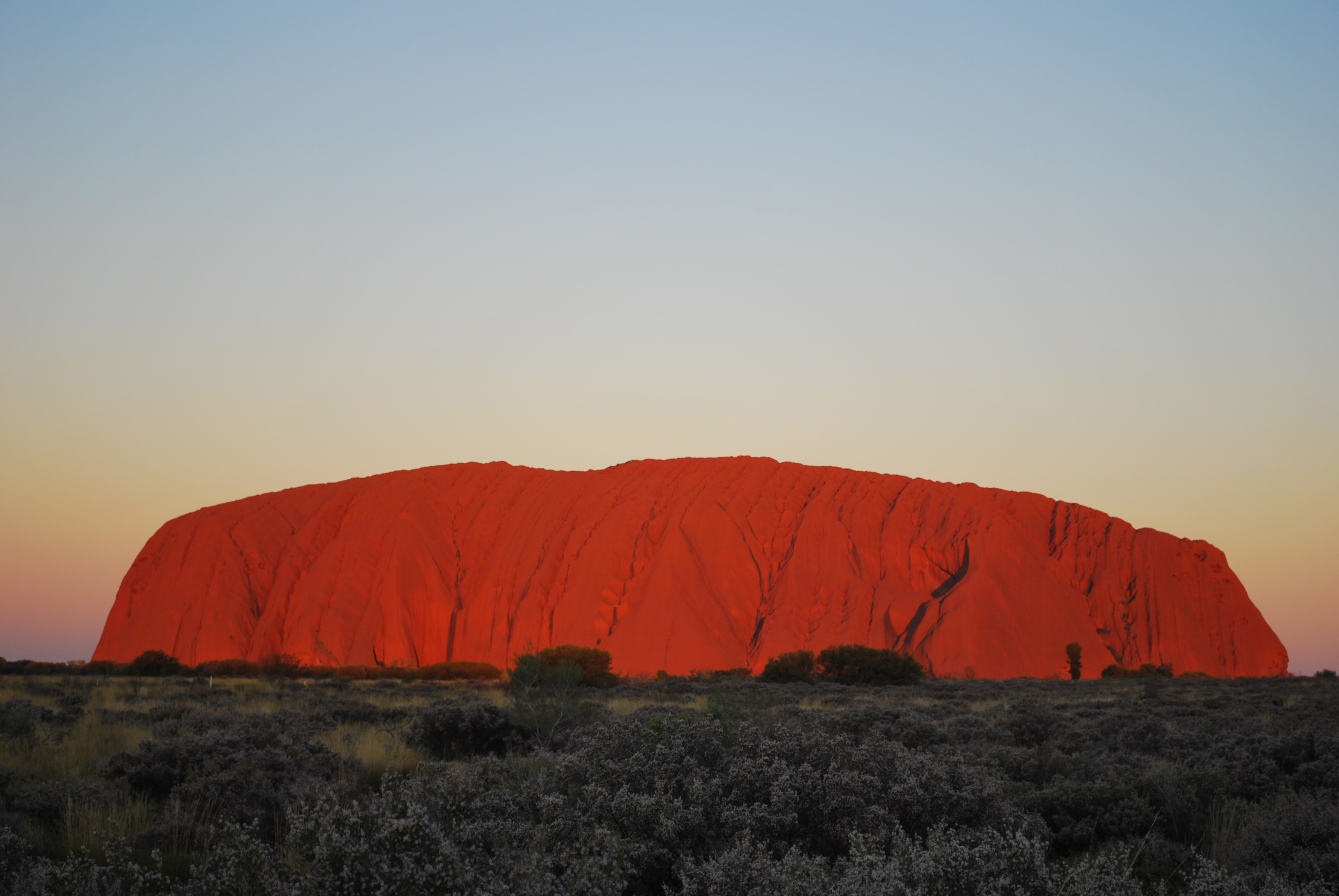 Article image for Debate rages as tourists flock to Uluru to climb it before it’s officially banned