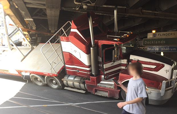 Article image for Truck stuck under bridge at major CBD intersection