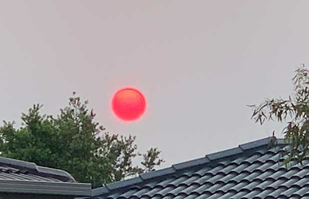 Article image for Photos: Eerie ‘red orb’ starts another smoky day in Melbourne