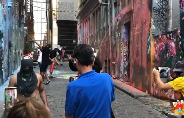 Article image for Video: Masked killjoys kick out tourists to ‘obliterate’ Hosier Lane art