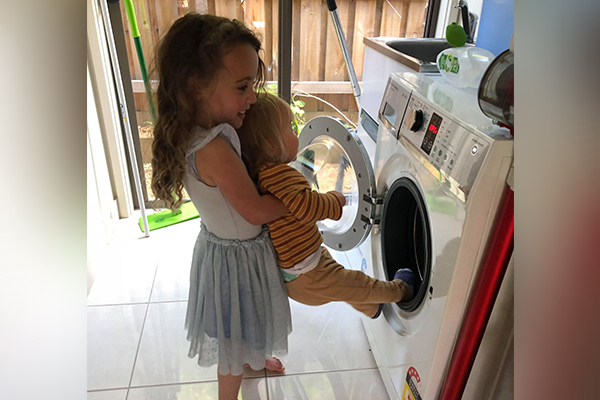 Article image for Mum catches four-year-old stuffing little brother into washing machine