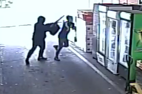 Article image for Frightening footage: Gun-wielding robber holds up Keysborough bottle shop