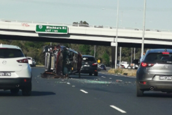 Article image for Car flips in the middle of the Eastern Freeway