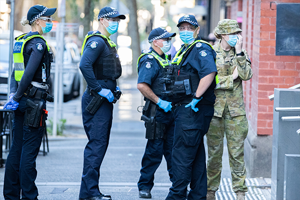 Police in masks standing outside Melbourne quarantine hotel