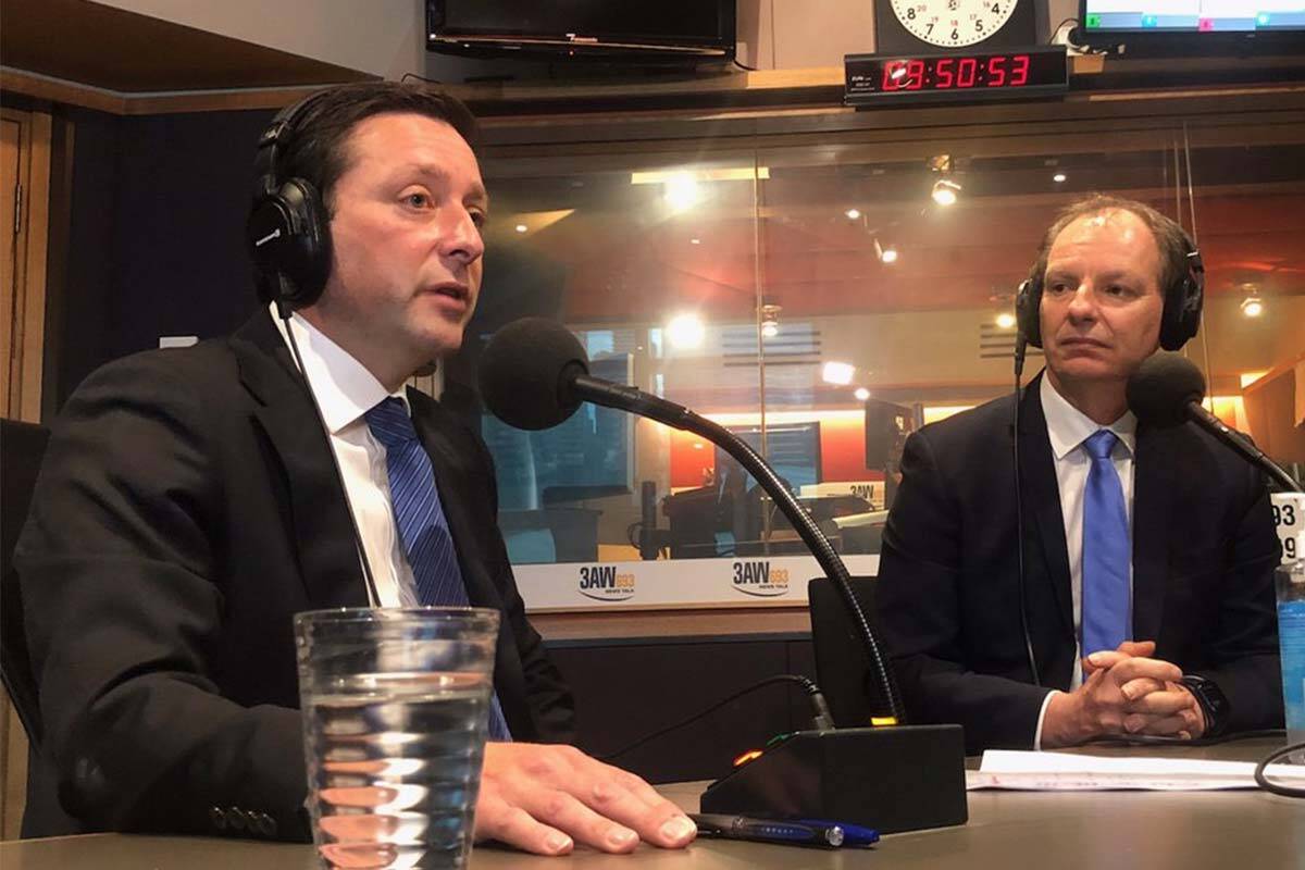 Matthew Guy and David Southwick in the 3AW studio wearing headphones and sitting in front of microphones