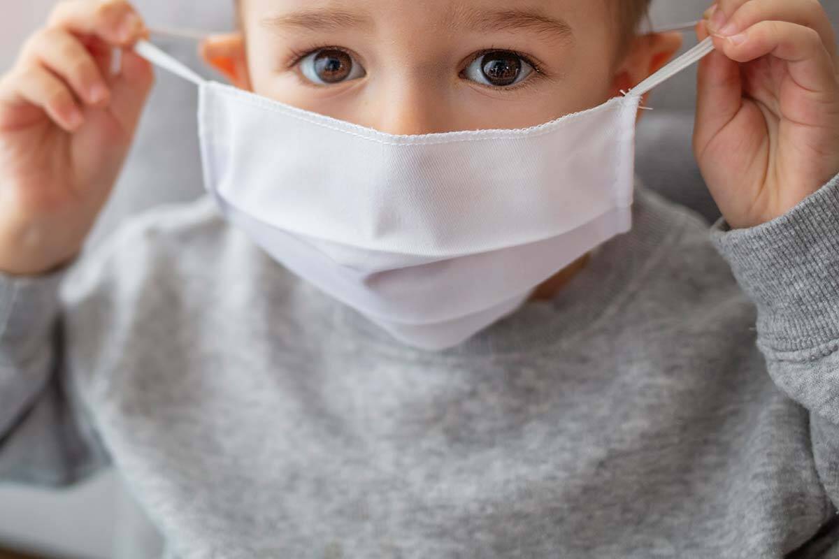 Young boy wearing a mask