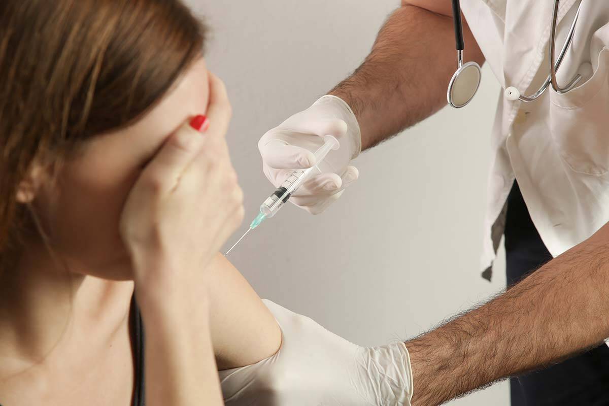 Frightened woman gets injection