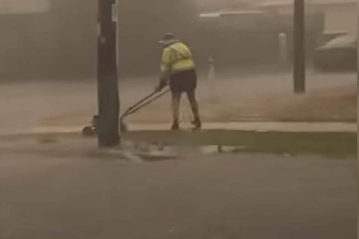 Article image for VIDEO: Geelong man mows the lawn during savage storm