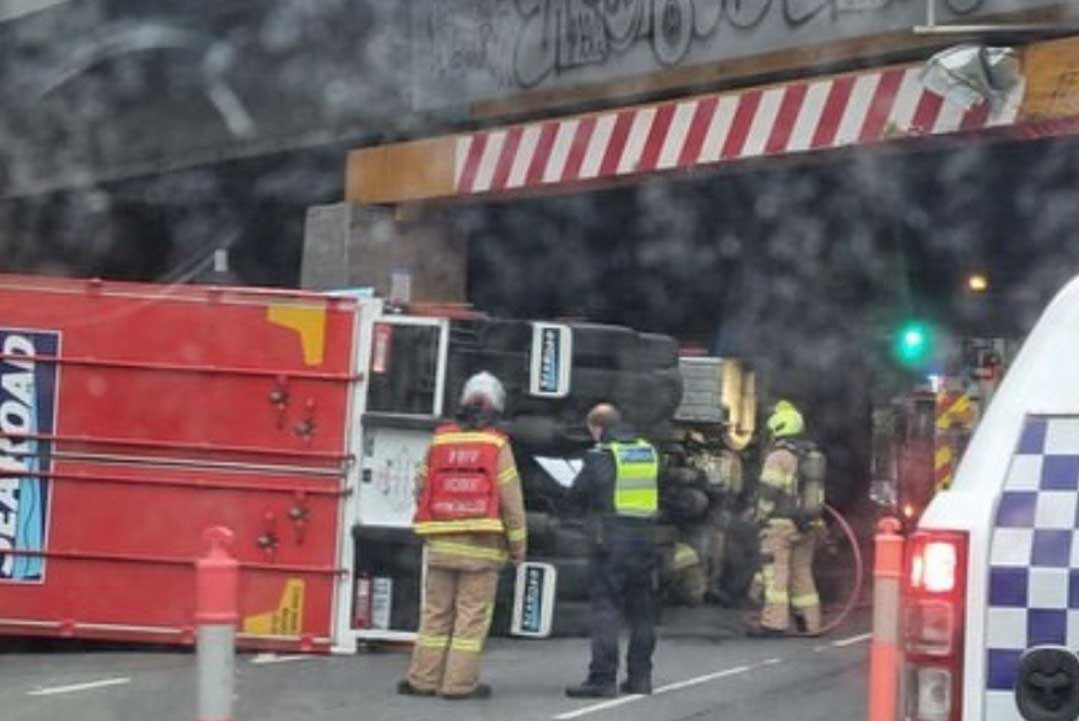 Article image for Truck rolls after hitting bridge in the CBD